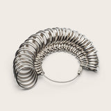 Metal ring sizer on a white background.